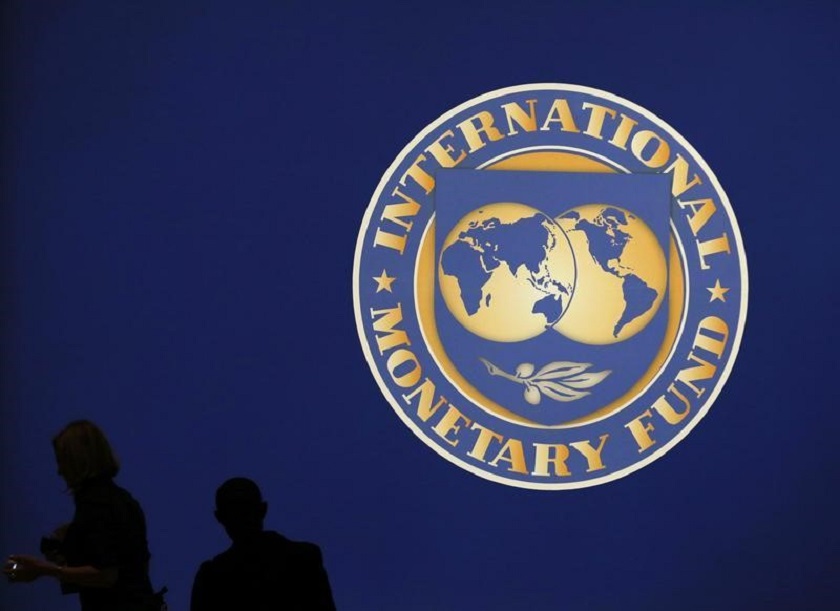 Visitors are silhouetted against the logo of the International Monetary Fund (IMF) in this file picture. u00e2u20acu201d Reuters pic 