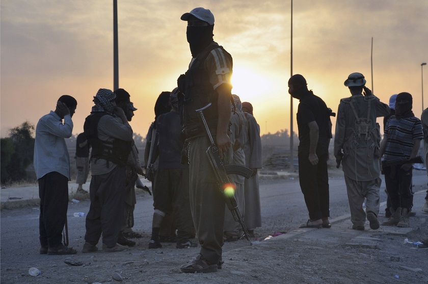Fighters of the Islamic State of Iraq and the Levant stand guard at a checkpoint in the northern Iraq city of Mosul, in this June 11, 2014 file photo. u00e2u20acu201d Reuters pic 