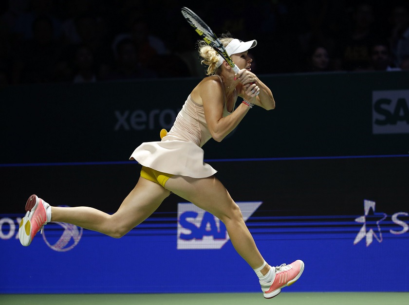 Caroline Wozniacki of Denmark hits a return to Petra Kvitova of the Czech Republic during their WTA Finals singles tennis match at the Singapore Indoor Stadium October 24, 2014.  u00e2u20acu201d Reuters pic 