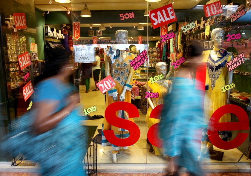 Women walk past a shop advertising Deepavali items for sale in Little India, Brickfields, Kuala Lumpur, October 17, 2014. u00e2u20acu201d Picture by Yusof Mat Isa