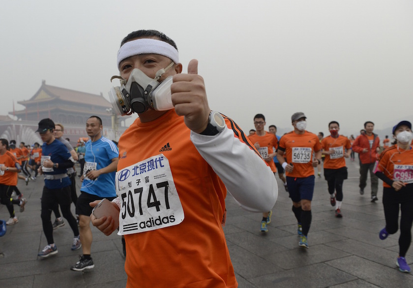 Participants wearing masks during a hazy day at the Beijing International Marathon in front of Tiananmen Square, in Beijing, October 19, 2014. u00e2u20acu201d Reuters pic