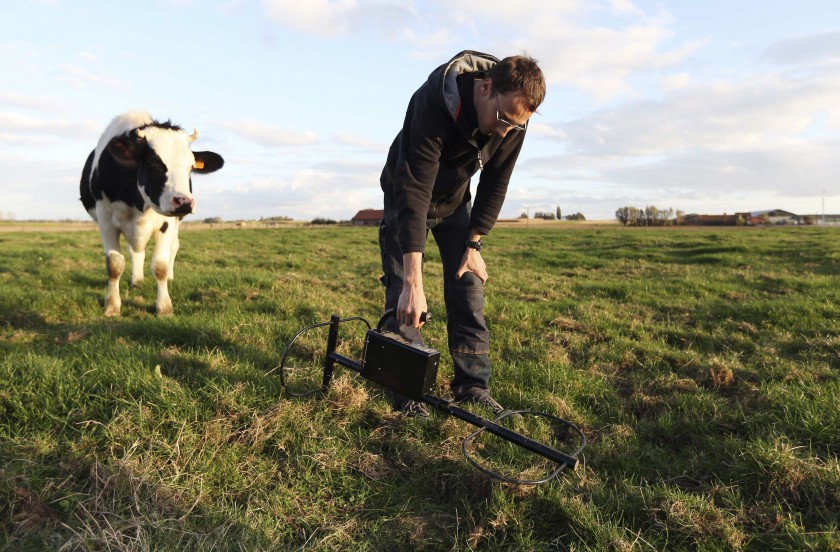 Belgian Stijn Butaye checks for World War One artefacts with a metal detector at his family's farm near Zonnebeke October 20, 2014. u00e2u20acu201d Reuters pic