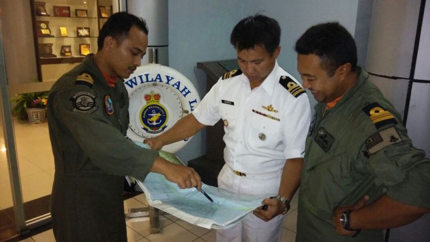 Royal Malaysian Navy tactical air coordinator lieutenant commander Mohd Fais Idris(left) briefing Chief of Staff operations lieutenant commander Mohd Harris Sadi (centre) of the medical evacuation of two sick navy crew onboard CB204.. u00e2u20acu201d Picture by Julia