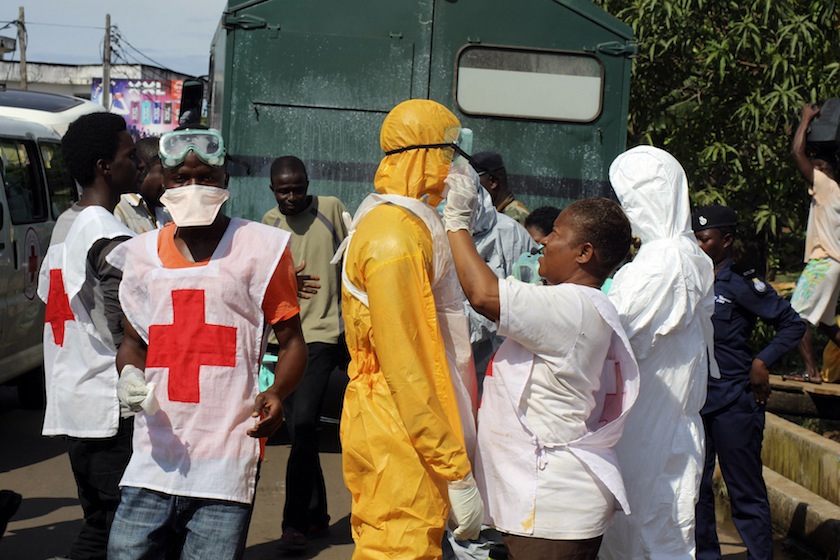 A health worker fixes another health worker's protective suit in the Aberdeen district of Freetown, Sierra Leone, October 14, 2014. u00e2u20acu201d Reuters pic