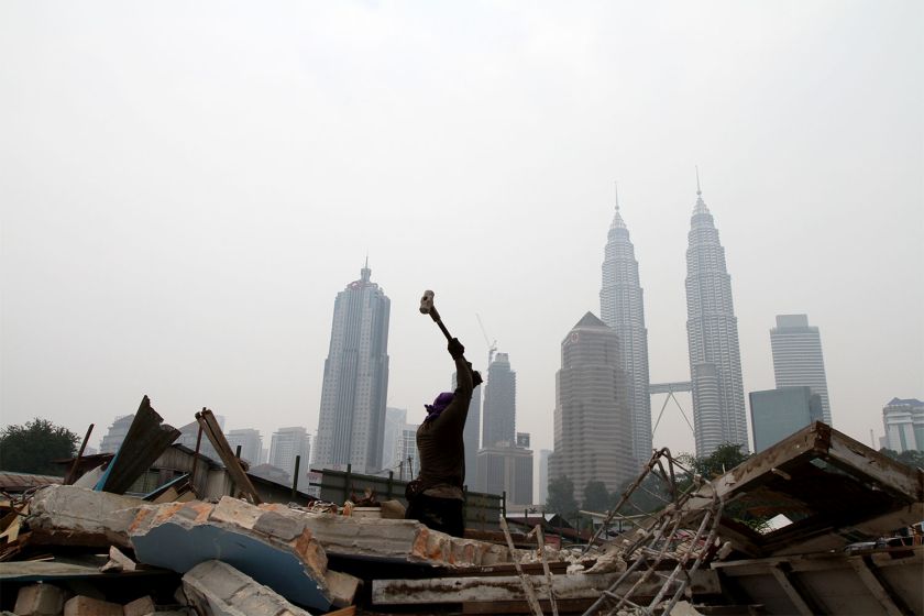 A foreign workers get on with his daily task at a residential area that was demolished for development on a hazy day in Kuala Lumpur, October 7, 2014. u00e2u20acu201d Picture by Yusof Mat Isa  