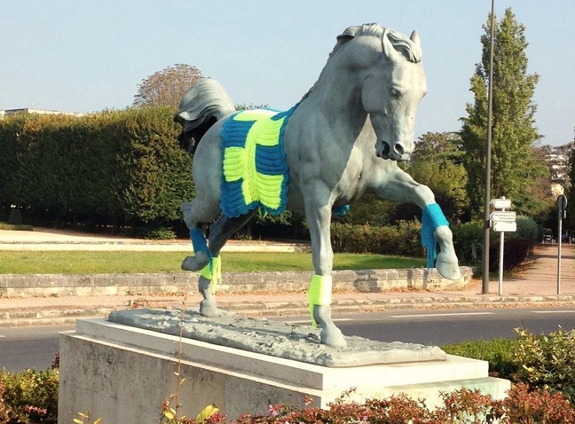 Chaconne, a stately bronze horse that greets visitors to the 17th century Chateau de Maisons-Laffitte, dressed in the latest knitwear. — Pictures by Helen Hickey