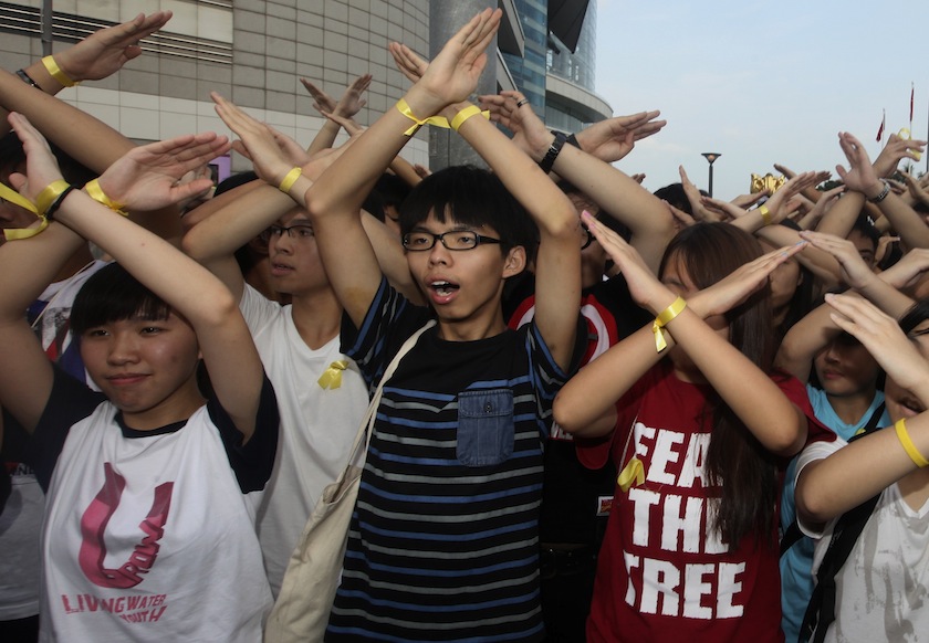 Scholarism founder Joshua Wong (centre) and other members chant slogans during a flag raising ceremony in Hong Kong October 1, 2014, celebrating the 65th anniversary of China National Day. u00e2u20acu201d Reuters pic
