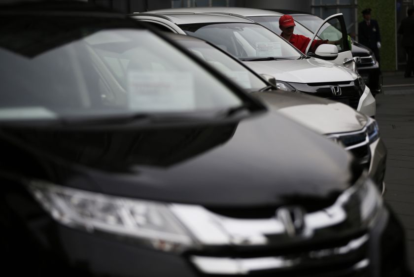 A staff member cleans a Honda Motor Co's car at the company's showroom in Tokyo October 27, 2014. u00e2u20acu201d Reuters pic