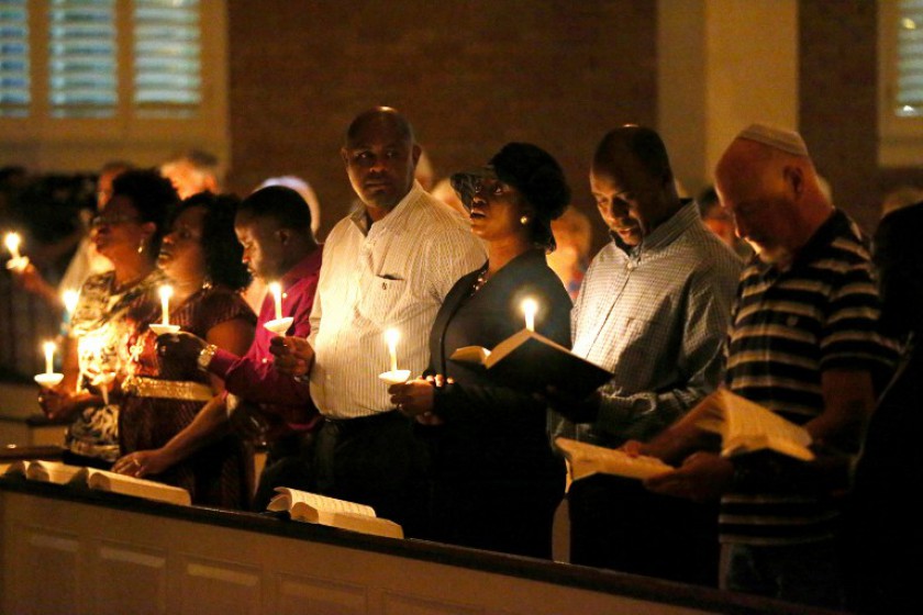 People hold candles during a prayer vigil and memorial at Wilshire Baptist Church for Thomas Eric Duncan after he passed away from the Ebola virus on October 8, 2014 in Dallas, Texas. — AFP pic