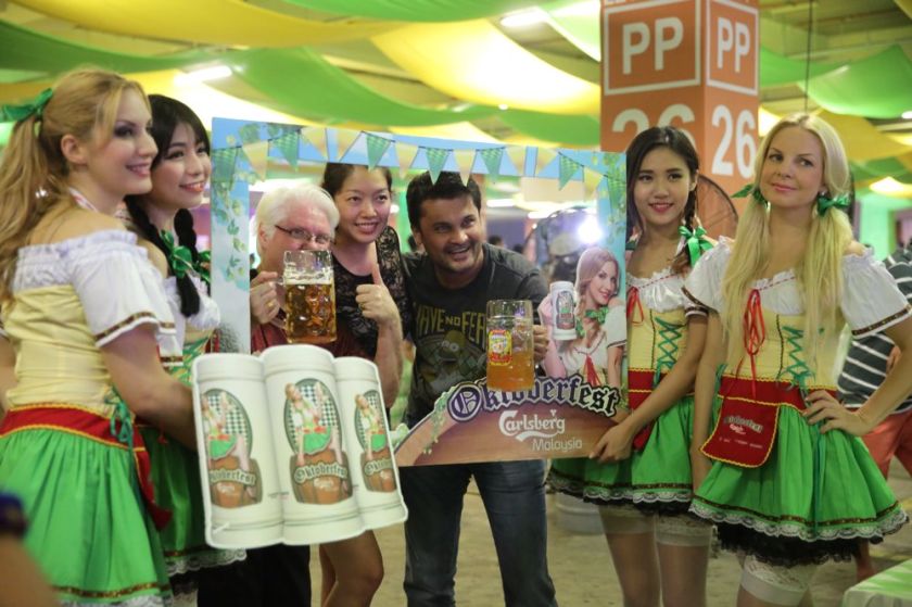 Revellers taking photos with lederhosen girls at Oktoberfest held in 1Utama shopping mall in Petaling Jaya, October 11, 2014. u00e2u20acu201d Picture by Choo Choy May