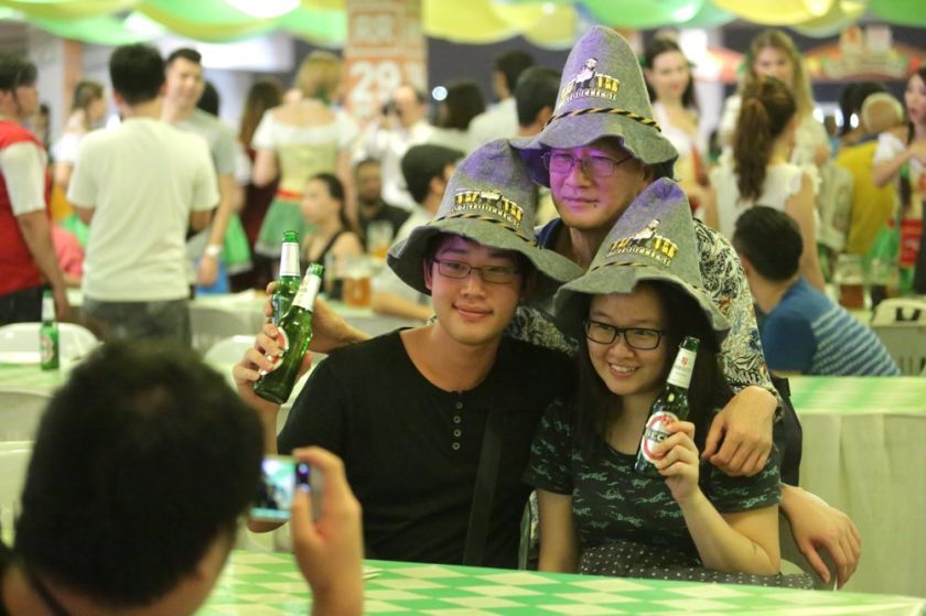 One for the album. People having their photo taken wearing the Oktoberfest Hat. — Picture by Choo Choy May