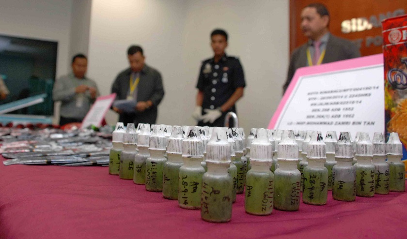 The recent drug bust at a luxury condo here included 540 bottles of green liquid laced with ecstasy. u00e2u20acu201d Picture by Julia Chan
