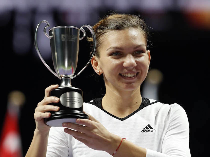 Simona Halep of Romania poses with the runneru00e2u20acu2122s up trophy after losing to Serena Williams of the US in the womenu00e2u20acu2122s singles final tennis match of the WTA Finals at the Singapore Indoor Stadium October 26, 2014. u00e2u20acu201d Reuters pic