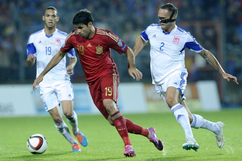 Diego Costa of Spain (left) fights for the ball with Maxime Chanot of Luxembourg (right) during their Euro 2016 qualification match at the Josy Barthel stadium in Luxembourg October 12, 2014. ― Reuters pic