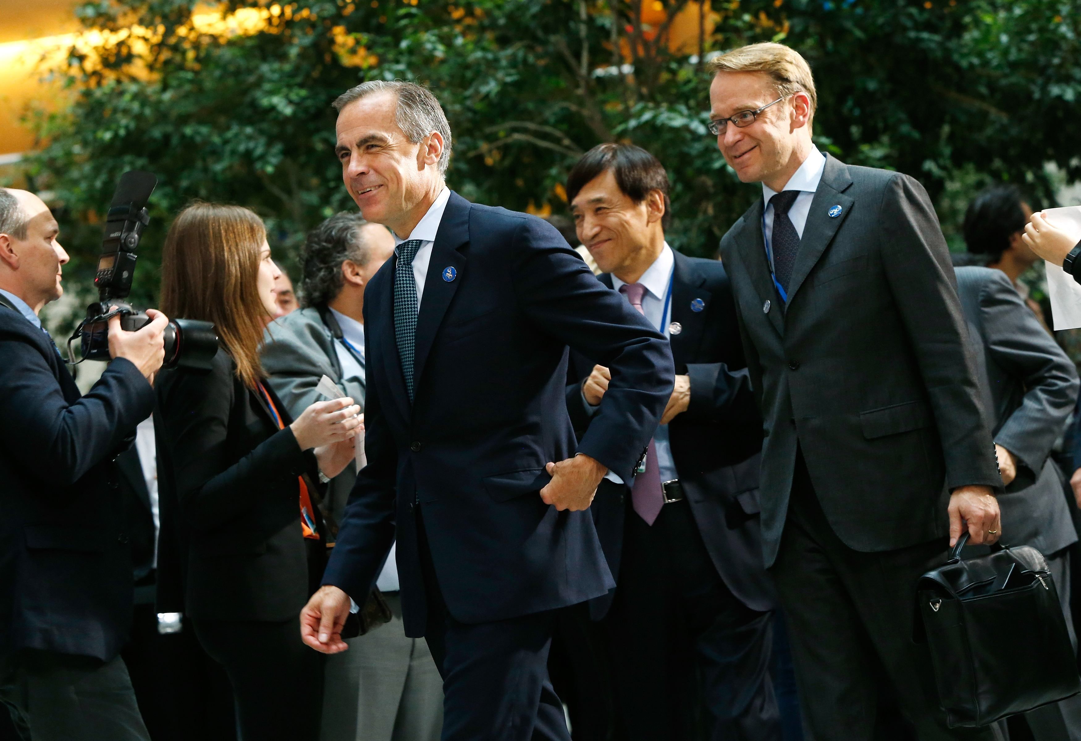 Bank of England Governor Mark Carney (left) and Germanyu00e2u20acu2122s Bundesbank President Jens Weidmann (right) walk to a family photo after a meeting of G-20 finance ministers in Washington October 10, 2014. u00e2u20acu201d Reuters pic
