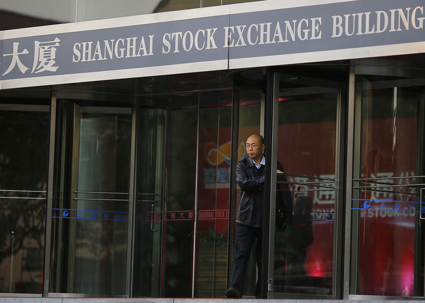 A man leaves the Shanghai stock exchange as Hong Kong and Shanghai launched their stock-linked index, November 17, 2014. u00e2u20acu201du00c2u00a0Reuters pic