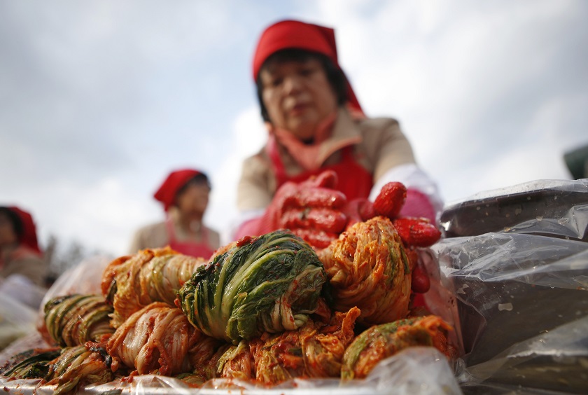 A woman makes traditional Korean side dish kimchi, or fermented cabbage, during the 2014 Seoul Kimchi Making and Sharing Festival at Seoul City Hall Plaza in Seoul November 15, 2014. u00e2u20acu201d Reuters pic
