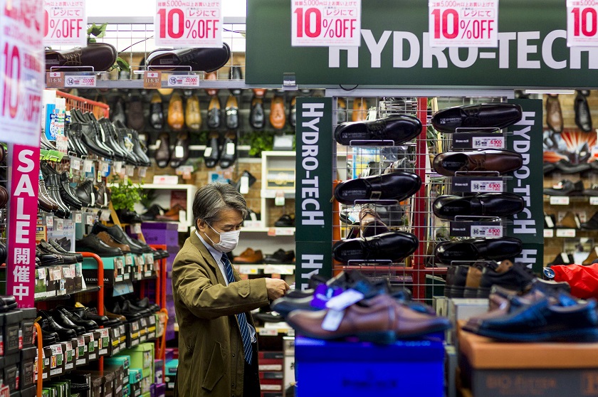A man looks at shoes in a shop at the Ameyoko market in Tokyo November 27, 2014. u00e2u20acu201d Reuters pic