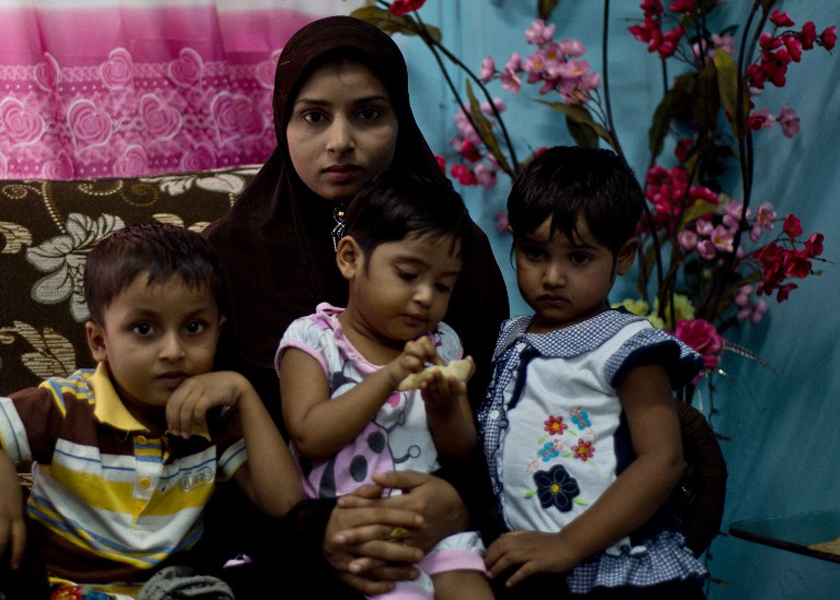 Bibijan Rahimullah, 27, poses with her three children. Bibijan stepped aboard a small boat in Myanmar for what she was told would be a week-long journey to Malaysia to escape violence, November 30, 2014. u00e2u20acu201d AFP pic