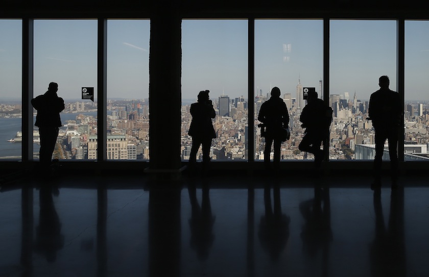 Members of the media look north at the Manhattan skyline from the 64th floor of the One World Trade Center tower in New York, November 3, 2014. u00e2u20acu201d Reuters pic