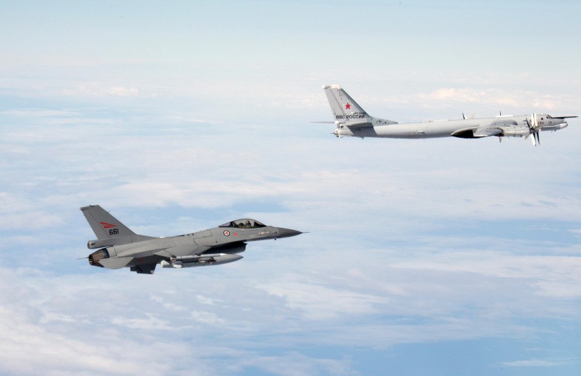 Picture provided by the Norwegian Army shows a Norwegian F-16 jet fighter (left) flying next to a Russian Tupolev Tu-95 strategic bomber over an unknown location. NATO aircraft tracked Russian strategic bombers over the Atlantic and Black Sea on October 2