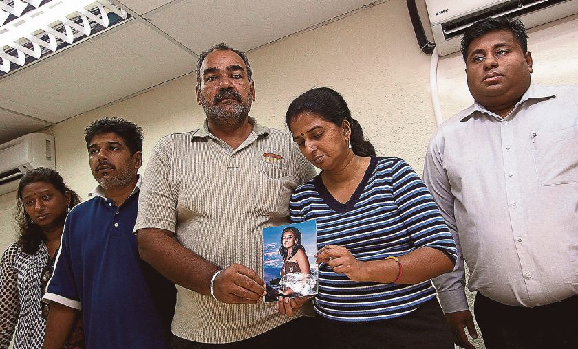 Ganesan and Uthayabavani hold a photo of Tinasha during a press conference yesterday. u00e2u20acu201d Picture by Zuraneeza Zulkifli