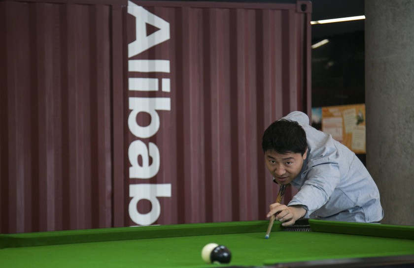 File picture shows a man playing snooker in a hall inside Alibabau00e2u20acu2122s headquarters in Hangzhou, Zhejiang province, China. Alibaba Group Holding posted net profit well below estimates even as revenues rose. u00e2u20acu201d Reuters pic