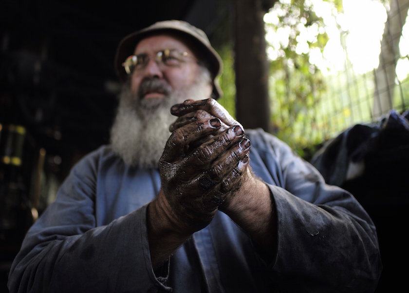Gary Pallister cleans grime off his hands after a day’s work on the Puffing Billy Railway at Belgrave station near Melbourne, October 17, 2014. — Reuters pic