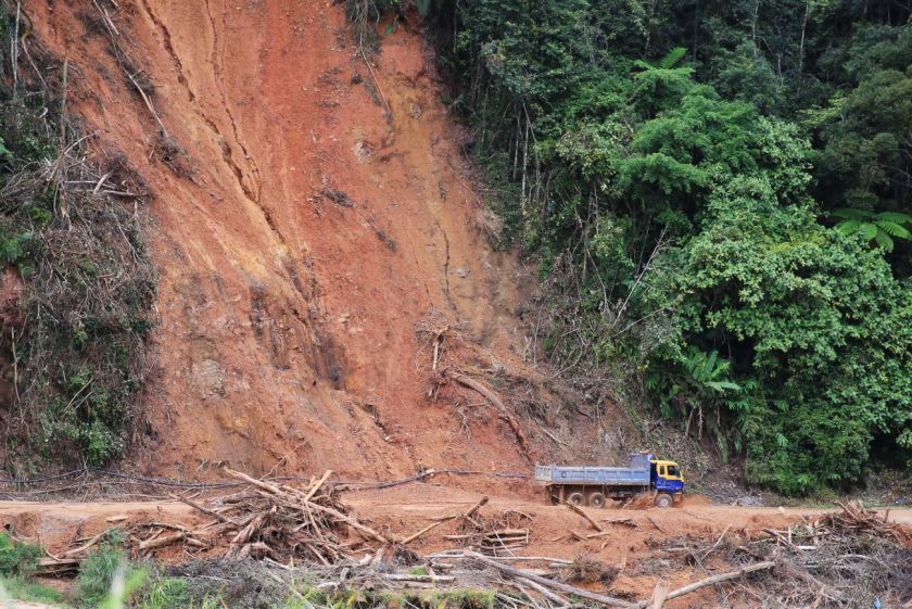 A lorry drives past an area hit by a landslide on the way from Tanah Rata to Habu. u00e2u20acu201d Picture by Saw Siow Feng