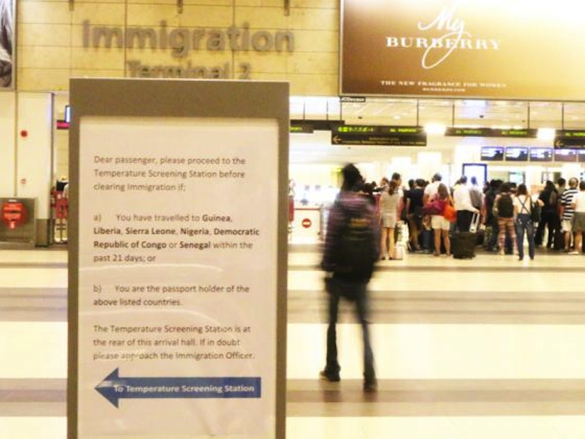A sign put up at the arrival hall of Changi Airport Terminal 2 directing arriving travelers from Ebola-affected countries for temperature screening. u00e2u20acu201d TODAY pic