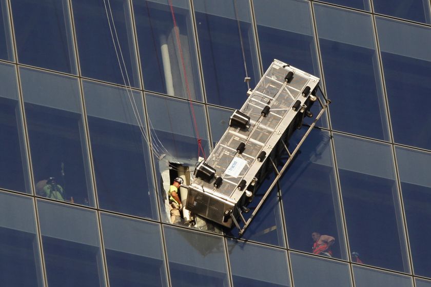 Workers look out at a broken scaffolding that had stranded window washers earlier on the World Trade Centre in New York November 12, 2014. u00e2u20acu201d Reuters pic