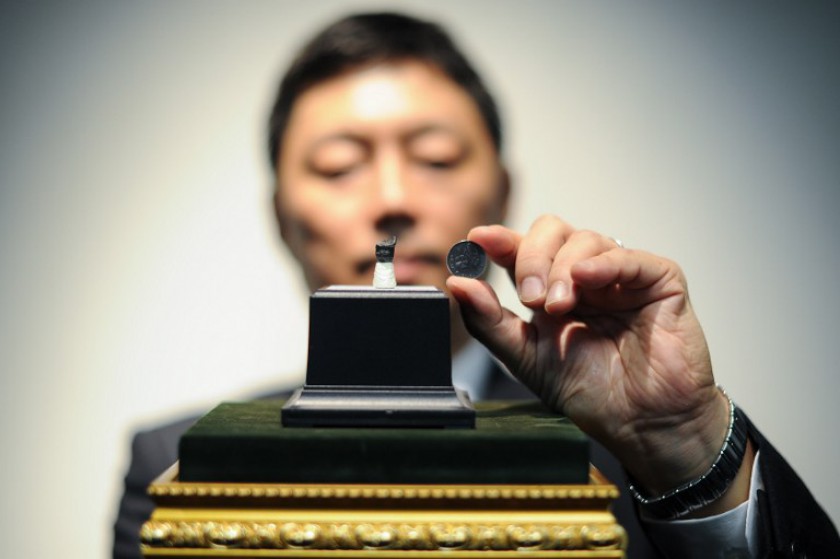Associate Professor Department of Geology, Dr Masatoshi Sone shows a fossil tooth of an ornithischian dinosaur at the University of Malaya in Kuala Lumpur on November 13, 2014. u00e2u20acu201d AFP pic