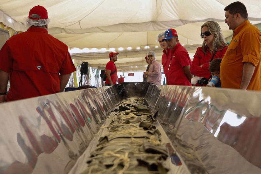 A giant hallaca u00e2u20acu201d a mixture of beef, pork, chicken, raisins, capers and olives wrapped in cornmeal dough and folded within plantain leaves, a typical Venezuelan Christmas dish u00e2u20acu201d in the making in an attempt to break the Guinness World Record for the bi