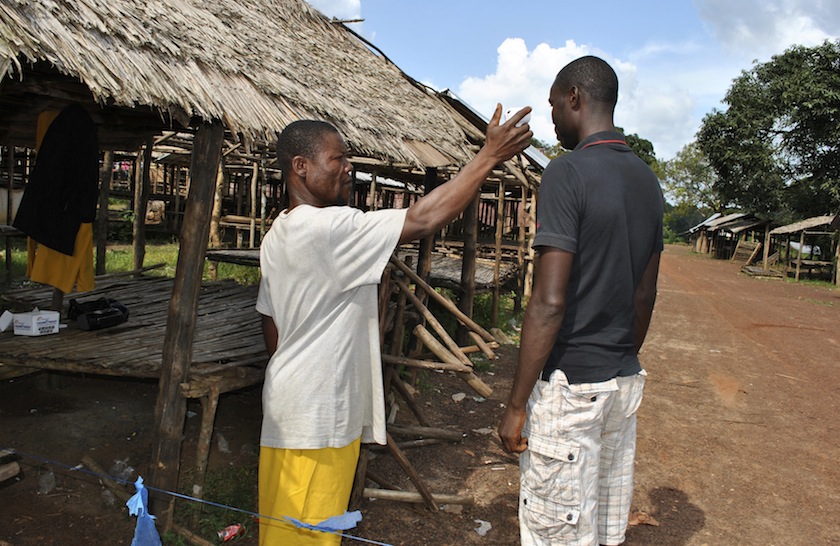 A community volunteer checks the temperature of a man before entering Jenewonde, in Liberia's Grand Cape Mount County, where local authorities say more than 20 people are suspected to have died of Ebola, October 30, 2014. u00e2u20acu201d Reuters pic