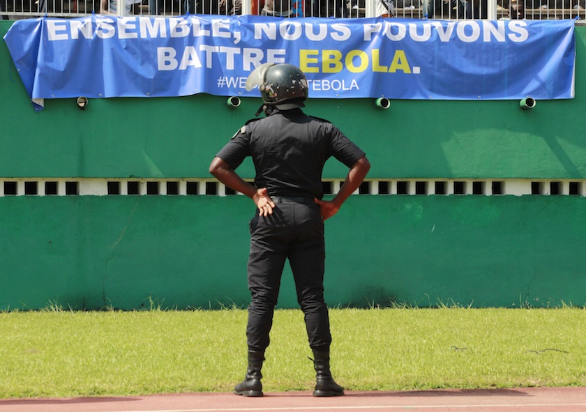 A stadium security officer stands in front of a banner during the African Nations Cup qualifying match between Ivory Coast and Cameroon at the Felix Houphouet Boigny stadium in Abidjan, November 19, 2014. u00e2u20acu201du00c2u00a0Reuters pic