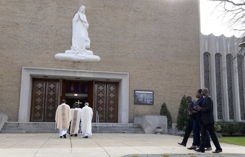 Isatu Salia (centre) the wife of the Sierra Leone-born physician who died of Ebola,  with her sons, Maada Martin (right) and Hinwaii Sakatty as they join he funeral procession in Landover Hills, Maryland, November 29, 2014.u00c2u00a0u00e2u20acu201d Reuters pic