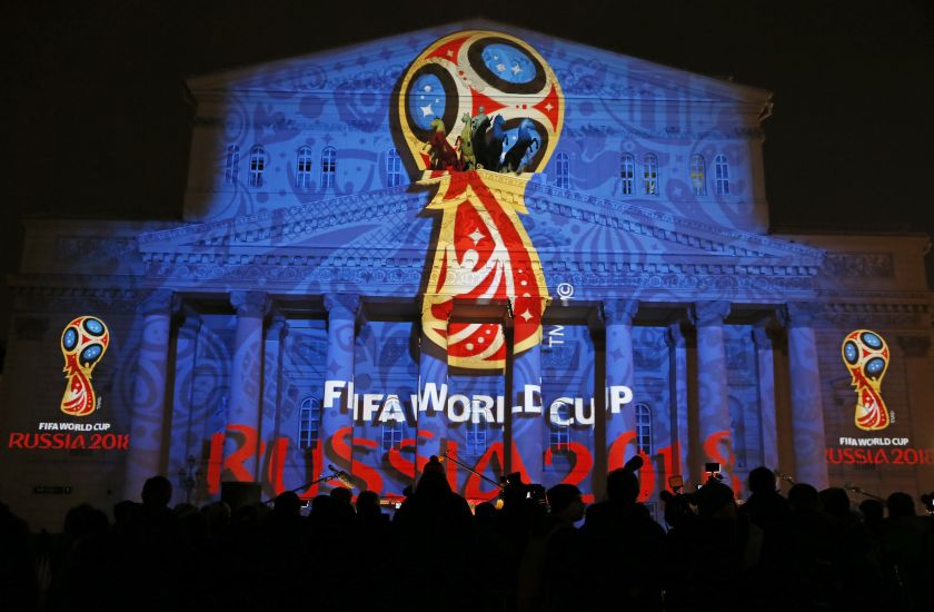 Journalists look at a light installation showing the official logotype of the 2018 FIFA World Cup during its unveiling ceremony at the Bolshoi Theater building in Moscow, October 28, 2014. u00e2u20acu201d Reuters pic