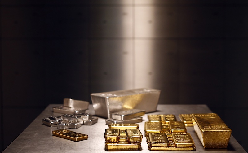 Gold and silver bars are stacked on a table in the safe deposit boxes room of the ProAurum gold house in Munich in this file photo taken March 3, 2014. u00e2u20acu201d Reuters pic