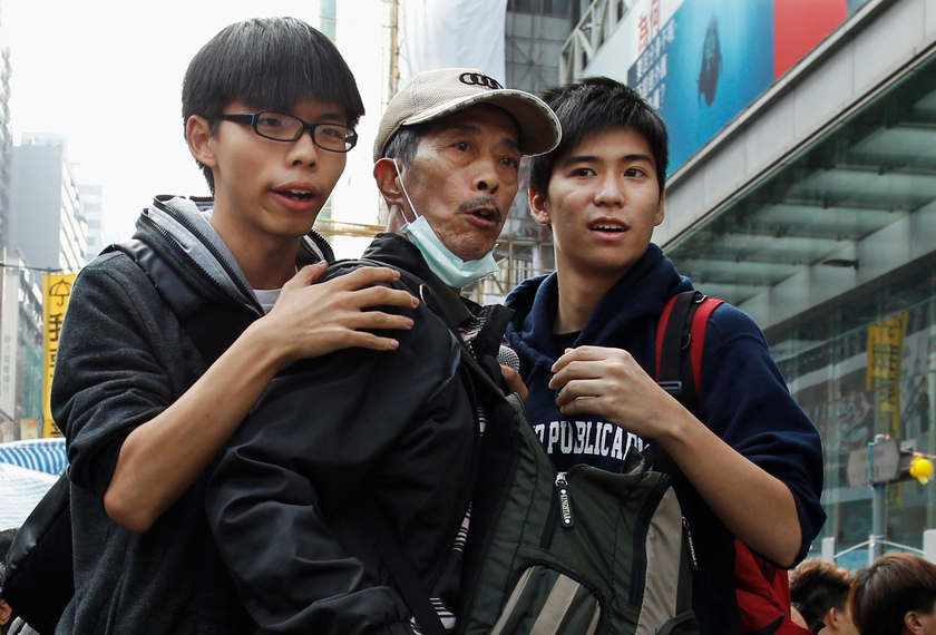Joshua Wong (left) and Lester Shum (right), hold back a protester behind a barricade at Mongkok shopping district in Hong Kong November 26, 2014. u00e2u20acu201d Reuters picn