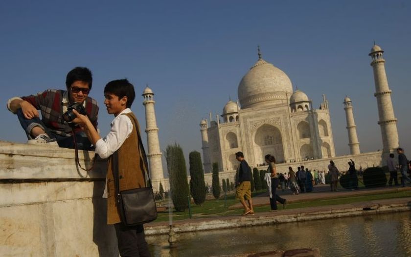 Tourists look at their camera after taking a picture near the UNESCO World Heritage site Taj Mahal in Agra, India. u00e2u20acu2022 AFP pic