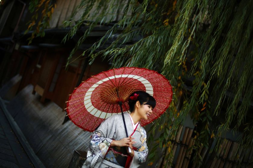 A woman, dressed in a traditional Japanese kimono, poses for tourists in Kyoto, western Japan November 20, 2014. u00e2u20acu2022 Reuters pic