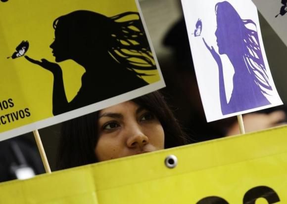 A member of Amnesty International attends a demonstration outside the El Salvador embassy in Mexico City, May 29, 2013, in support of a 22-year-old Salvadoran woman identified as Beatriz, who is seeking an abortion. Reuters