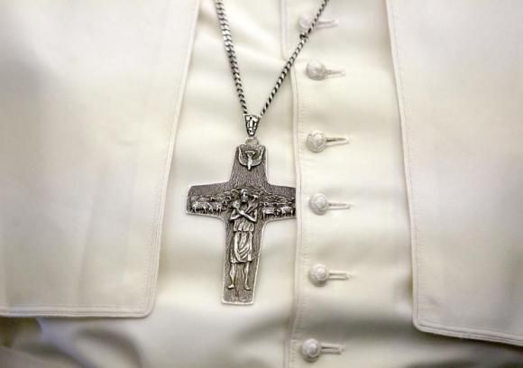 nnPope Francis wears a cross as he arrives for a one-day pastoral visit to Albania, in Tirana, September 21, 2014 Reuters