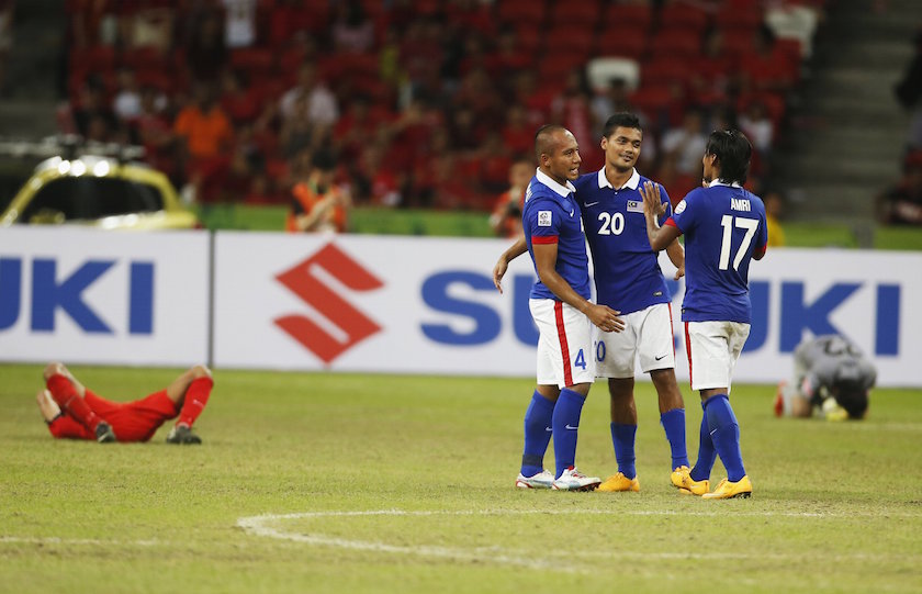 Malaysiau00e2u20acu2122s (from left) Mahalli Jasuli, Mohd Hafiz Kamal and Mohd Amri Yahyah celebrate defeating Singapore in their Suzuki Cup Group B match at the National Stadium in Singapore November 29, 2014. u00e2u20acu201d Reuters pic