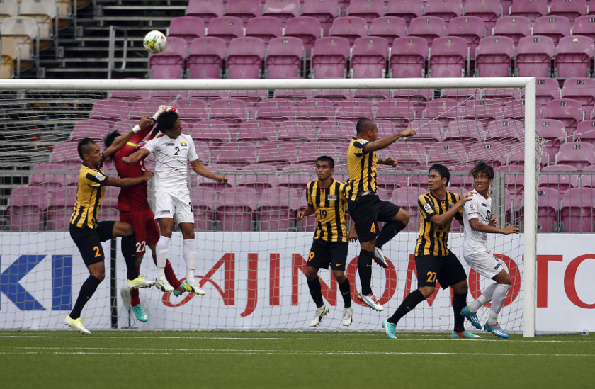 Malaysia's goalkeeper Khairul Fahmi Che Matn (2nd left) makes a save during their Suzuki Cup Group B match against Myanmar at Jalan Besar stadium in Singapore November 23, 2014. u00e2u20acu201d Reuters pic