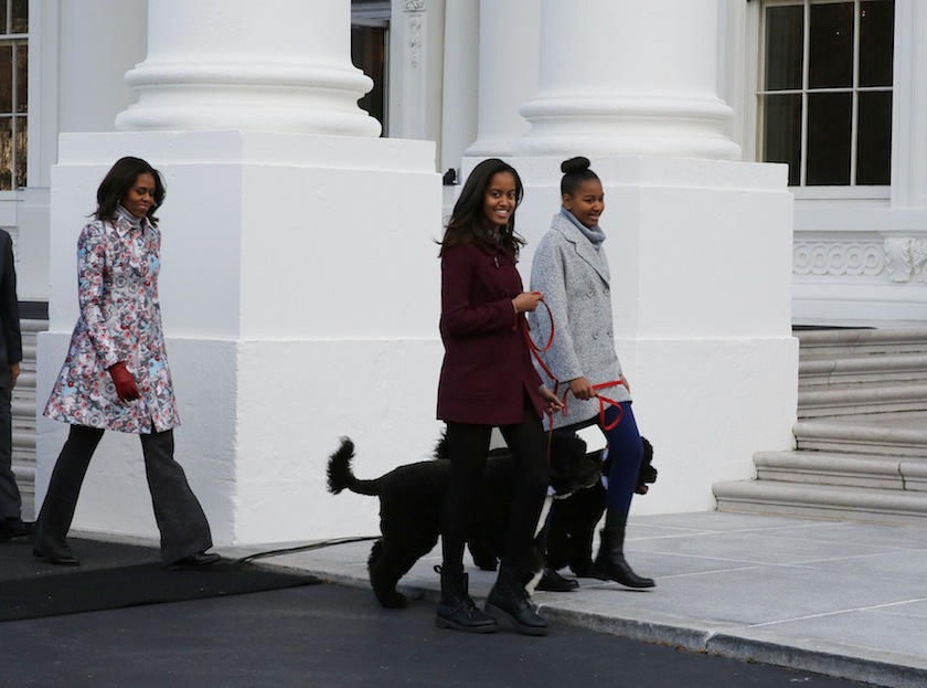 US first lady Michelle Obama (left) walks out with her daughters, Malia (centre) and Sasha, and the family dogs to receive the official White House Christmas tree at the North Portico of the White House in Washington November 28, 2014. u00e2u20acu201d Reuters pic