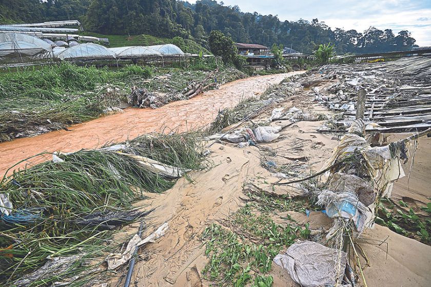The floods leave a muddy trail of destruction in Ringlet. u00e2u20acu201d Picture by Marcus Pheong