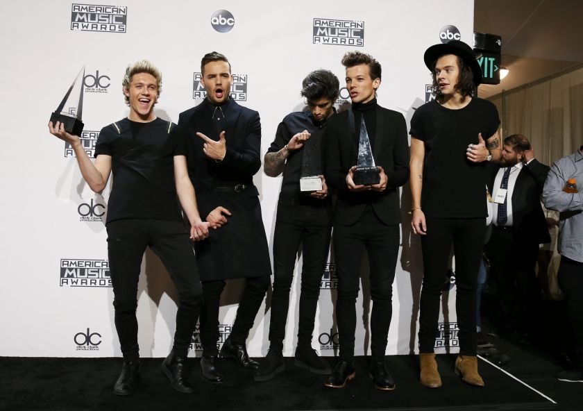 One Direction poses backstage with their awards for Favorite Rock/Pop Band/Duo/Group, Artist of the Year and Favorite Rock/Pop Album for 'Midnight Memories' during the 42nd American Music Awards in Los Angeles, California November 23, 2014.  u00e2u20acu201d Reuters p