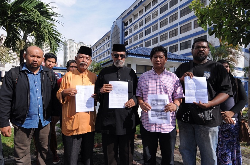 Perkasa members display the police report made against the false communist banners at the George Town Police district headquarters in Penang, November 28, 2014. — Picture by K.E. Ooi