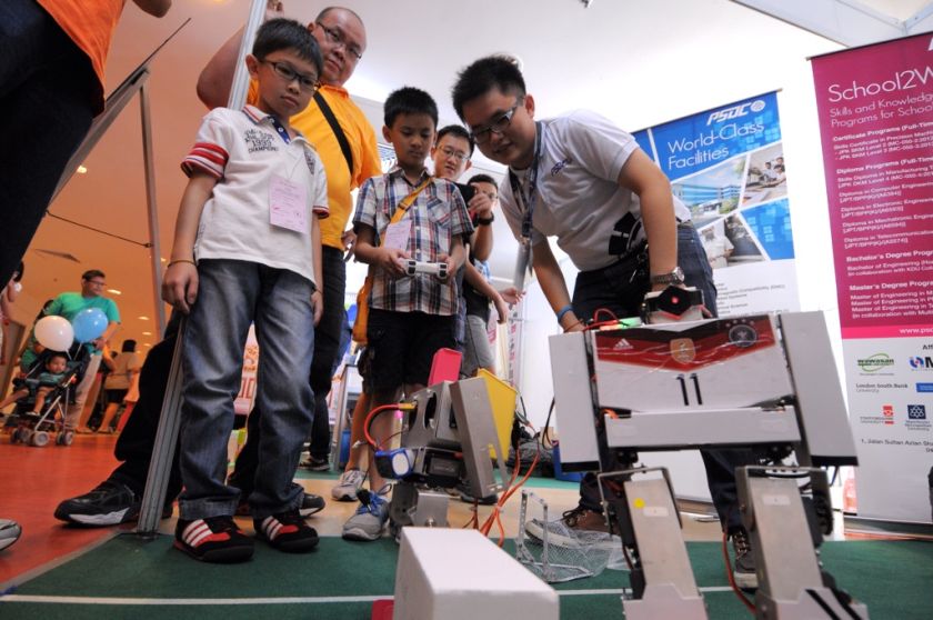 Visitors are seen admiring a remote-controlled robot during their visit to the Penang International Science Fair, November 15, 2014. u00e2u20acu2022 Picture by K.E. Ooi